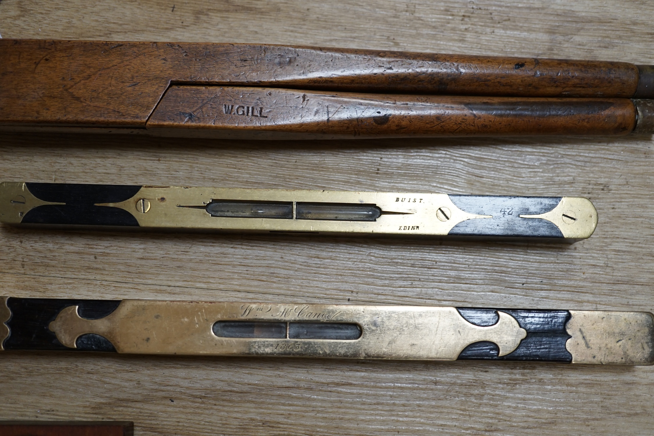 Two portable sundials, two brass inlaid spirit levels and a wood compass, wooden compass 34cm long. Condition - fair to good